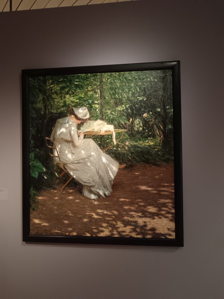 The painting of a woman reading in a park