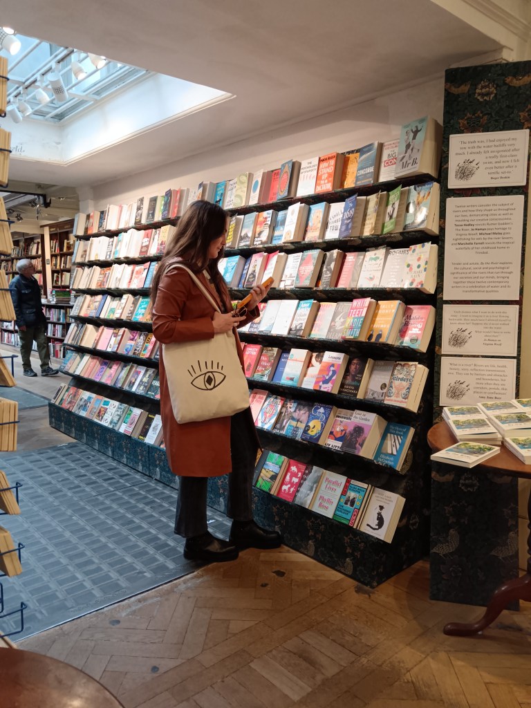 My sister browses a wall of books