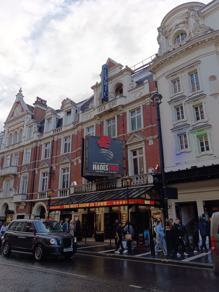 The exterior of the theatre with a sign foor Hadestown