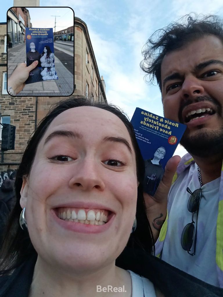 Bruno and I pull silly faces holding Sabina's flyers