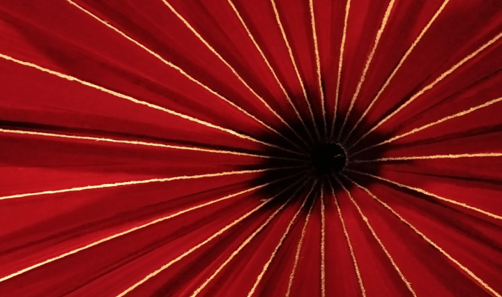 The centre of the roof of a red circus tent