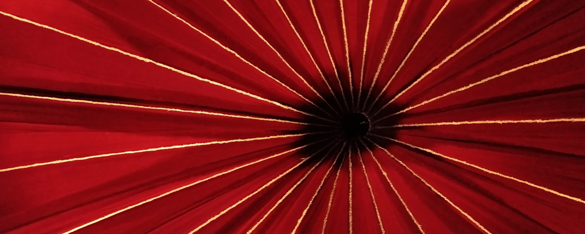 The centre of the roof of a red circus tent