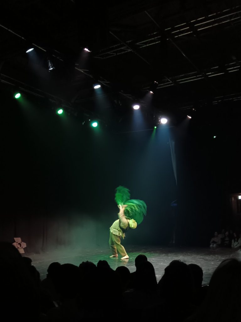 Shrek does a backbend with feather fans