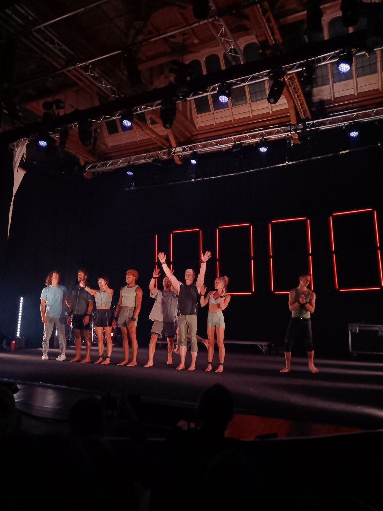 Acrobats smile and wave to the crowd