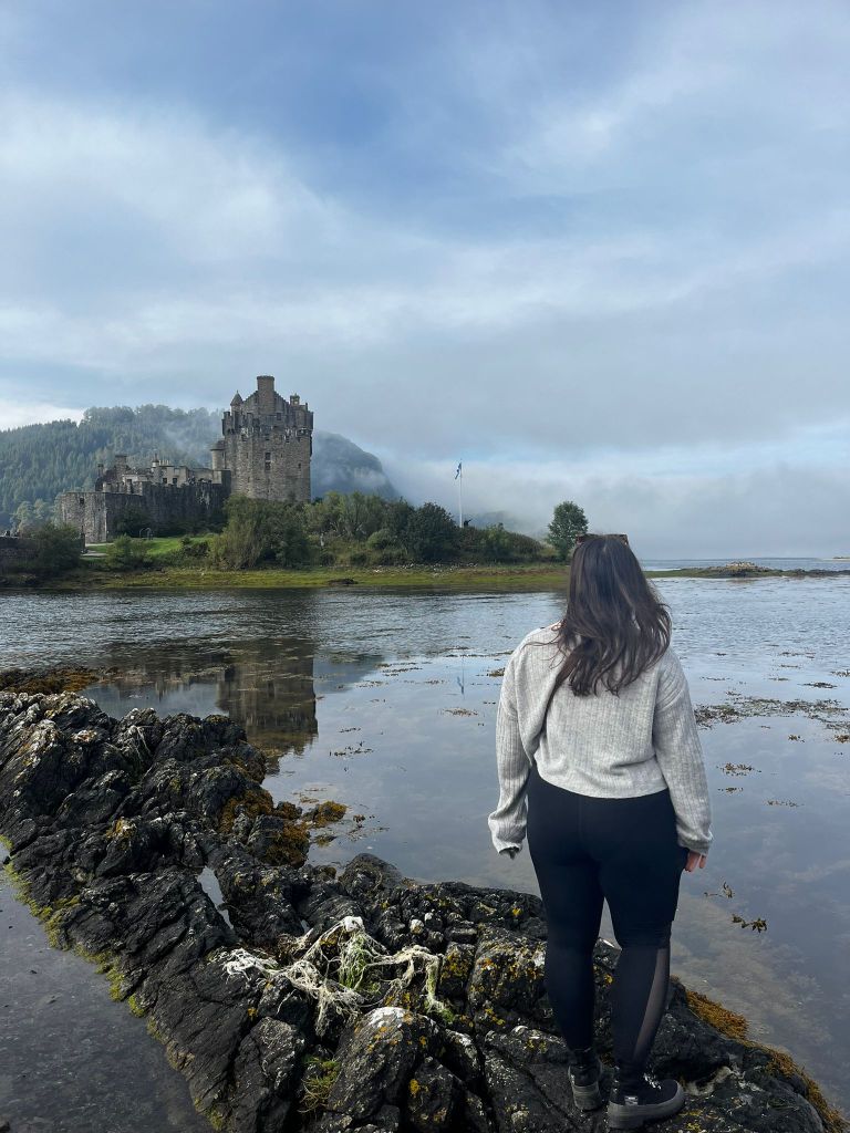 I stand on a rock looking at a castle