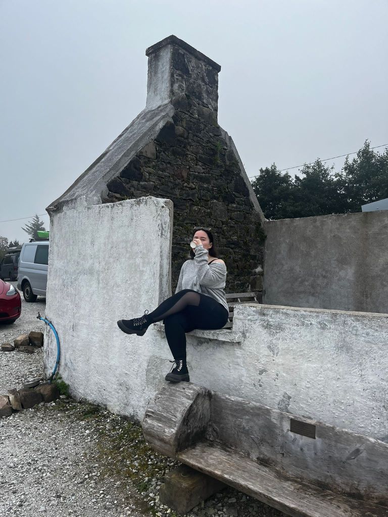 I sit on a wall drinking my latte