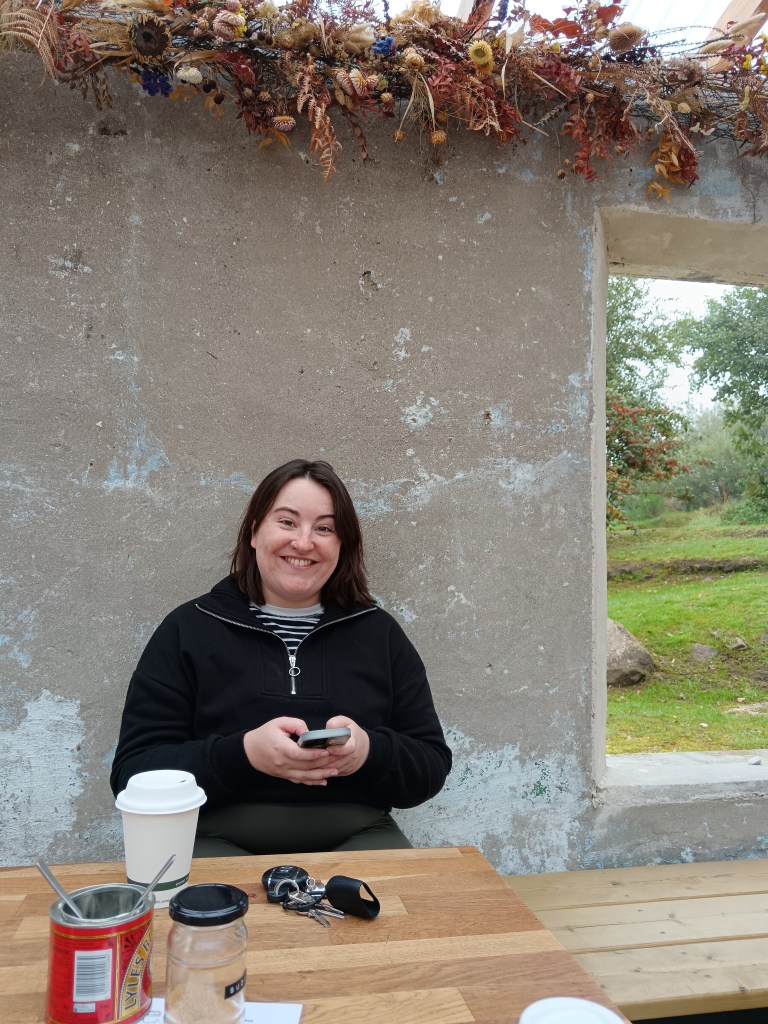 Erin smiles at me with her tea in hand