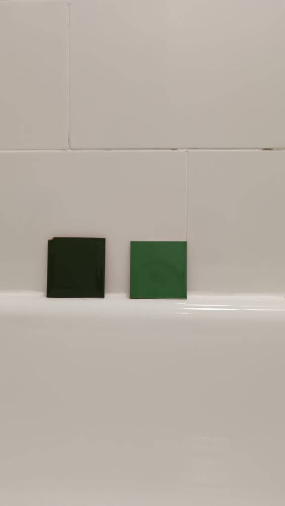 Two different green tiles against my bath