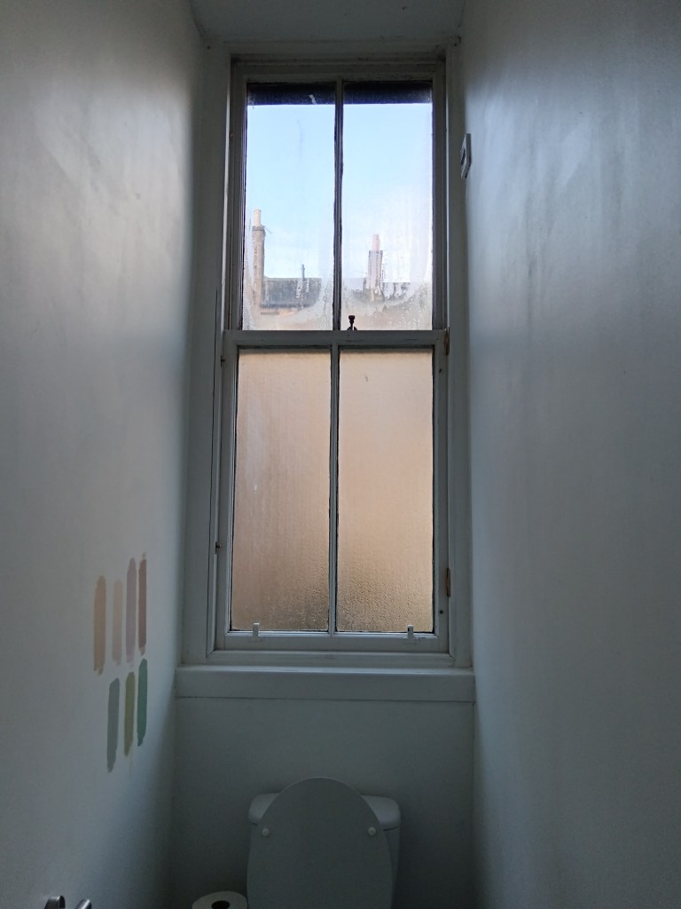 My old sash windows and some paint samples on the wall