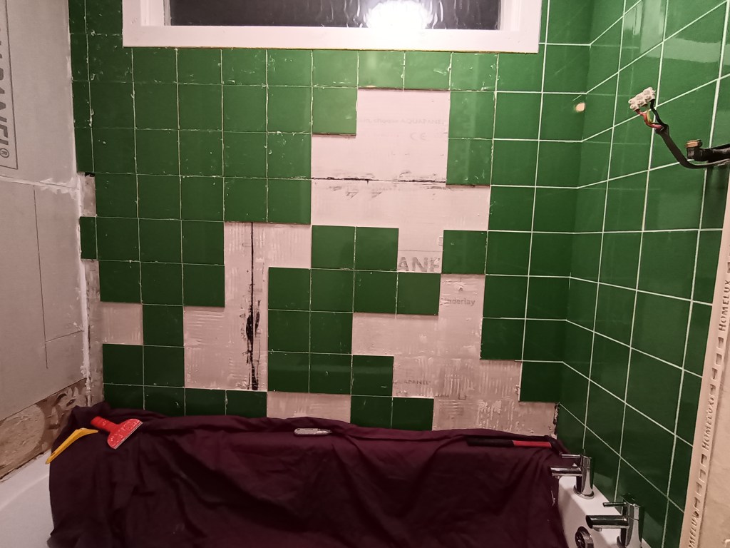 My bath area mid green tiles falling down