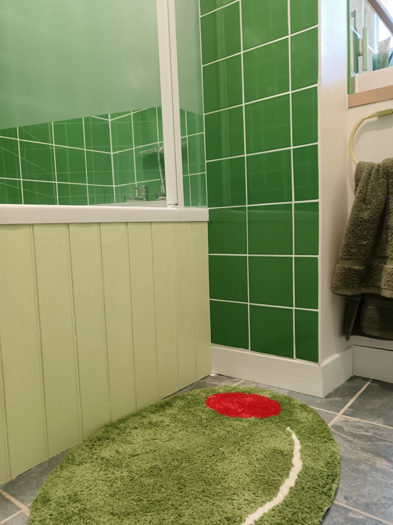 My green tiles, pale green bath panel and a stuffed olive bath mat