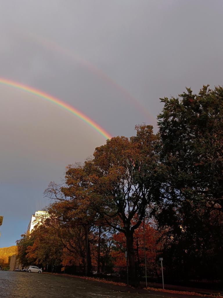 A double rainbow shines in the sky