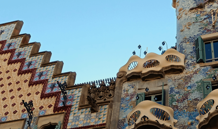 Two uniquely shaped and colourfully tiled buildings stand side by side