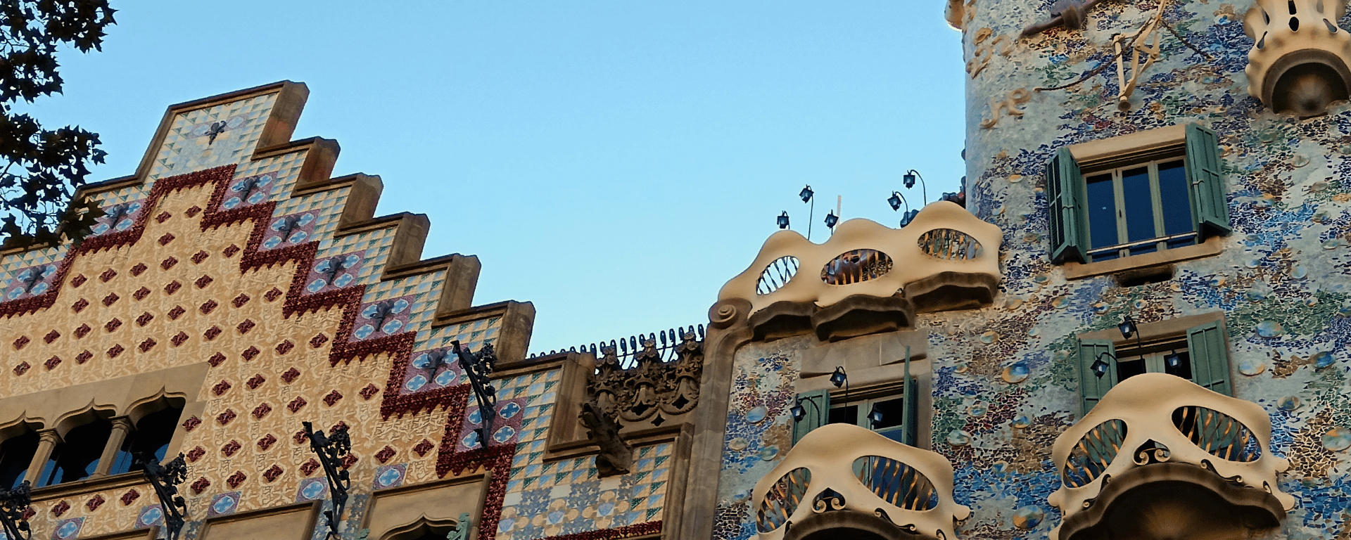 Two uniquely shaped and colourfully tiled buildings stand side by side