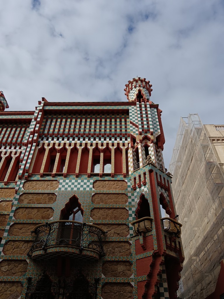 Green white and orange tiled building with turrets