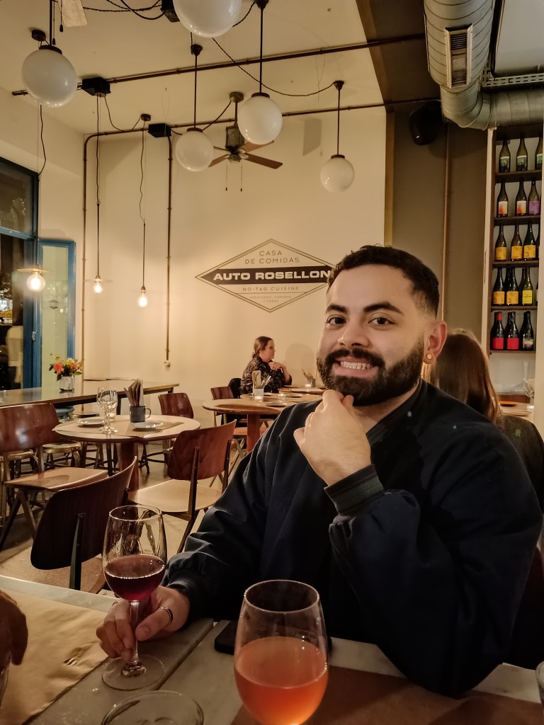 Leo smiles with a glass of wine