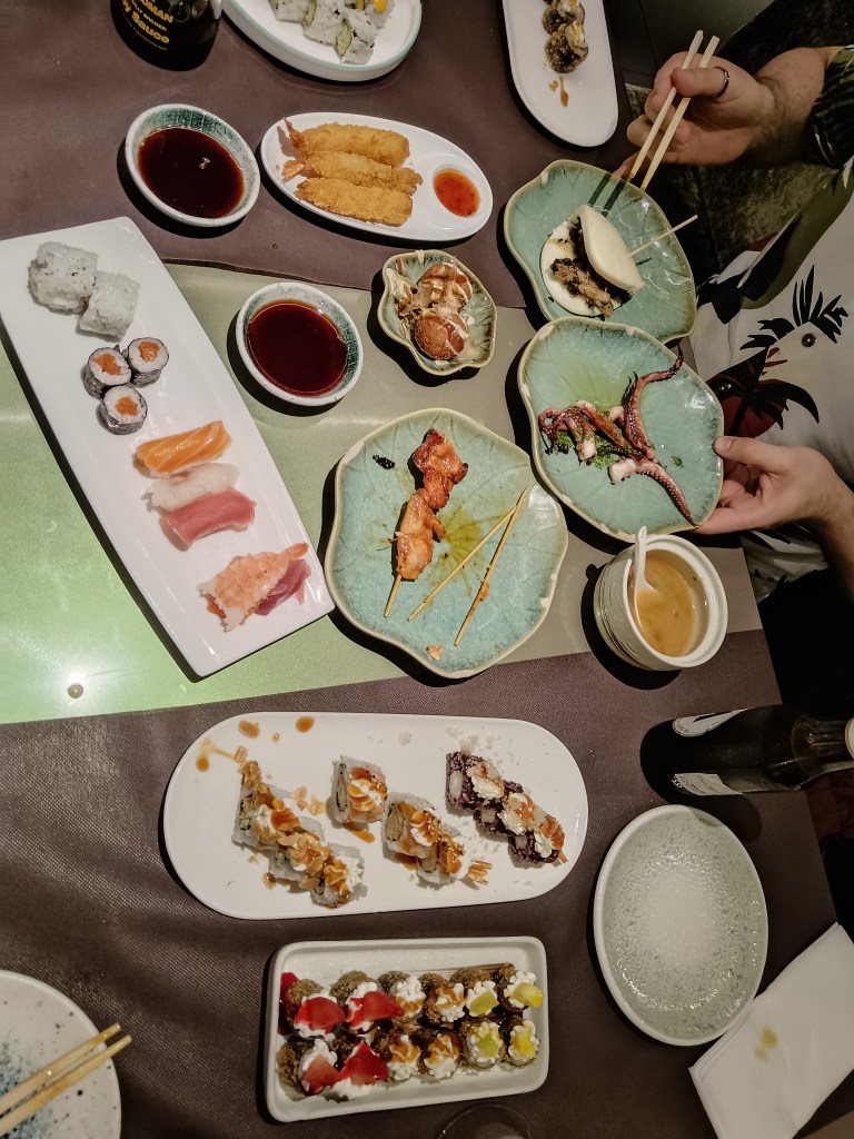 A table full of plates of sushi