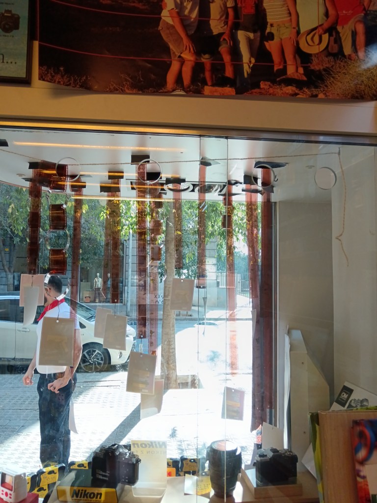 Rolls of film hang in a photography shop