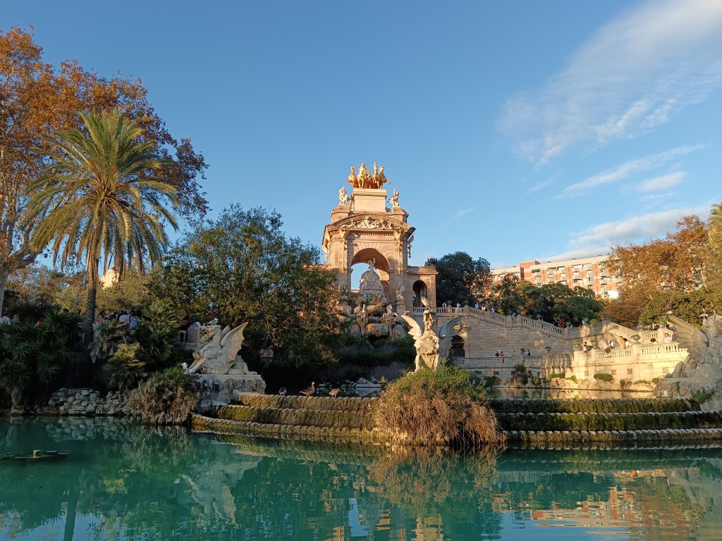 A grand fountain shines in the sun