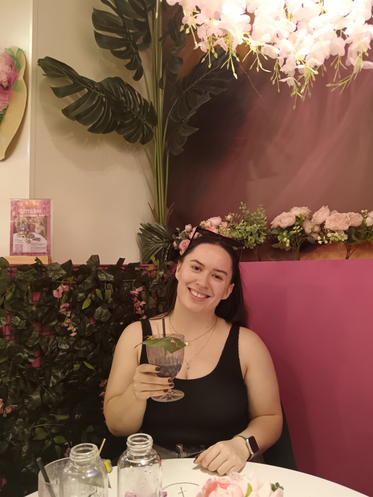 I smile holding a smoothie