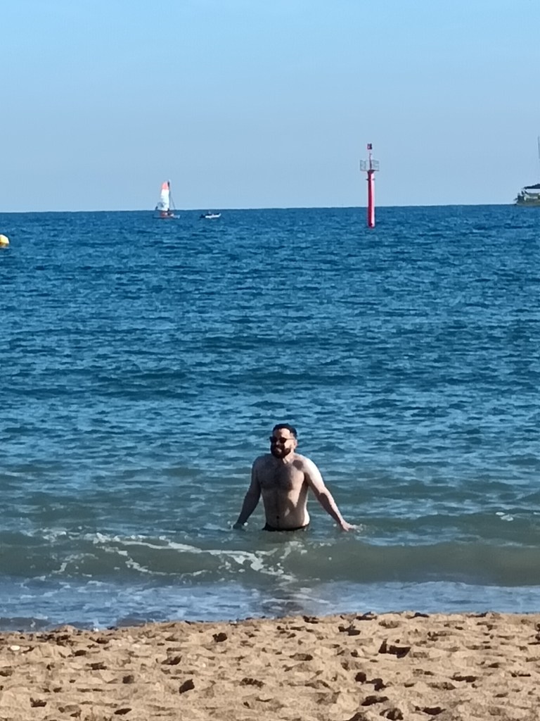 Leo winces at the cold of the water