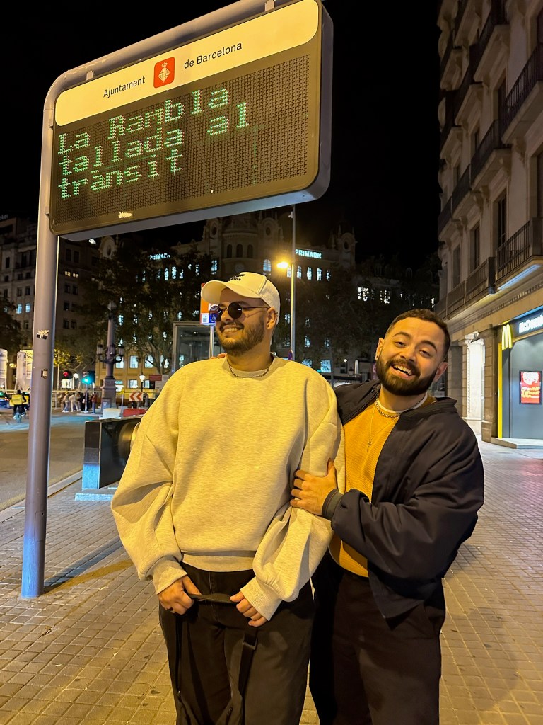Bruno and Leo stand together laughing