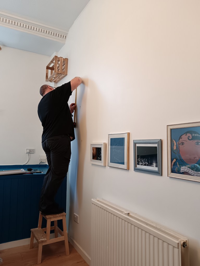 Dad measures for putting frames on the wall