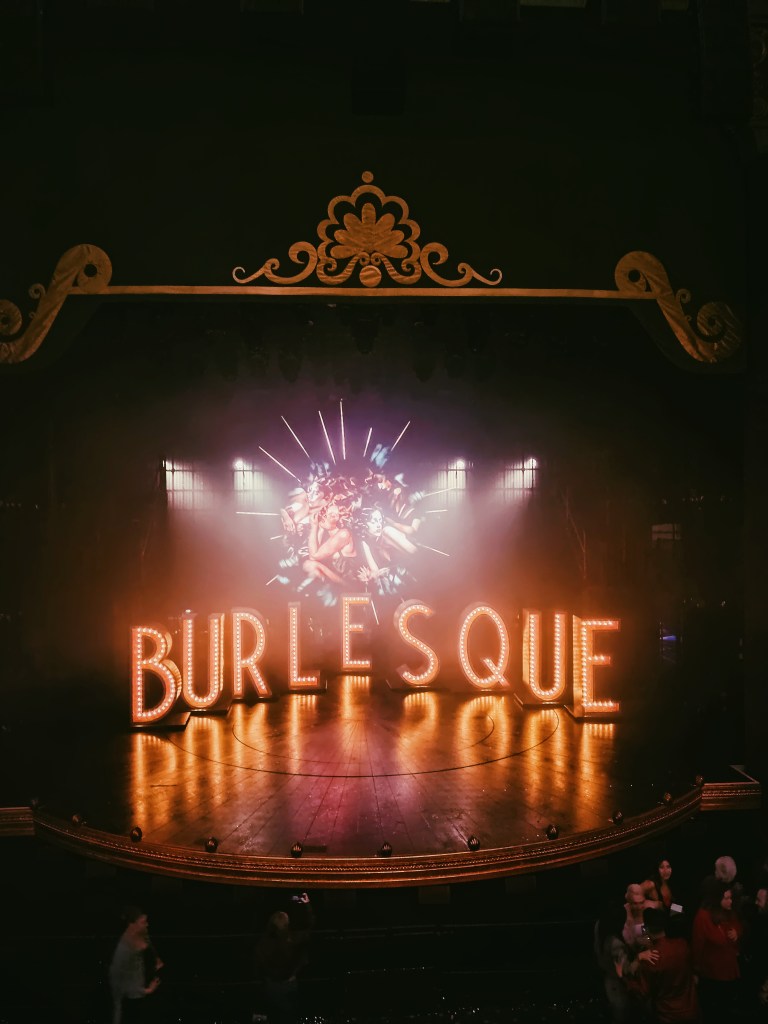 A stage filled with giant letters spelling BURLESQUE