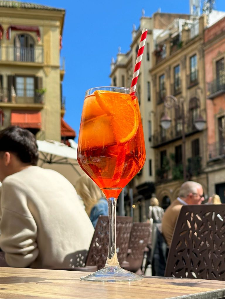 An aperol spritz glowing in the sun