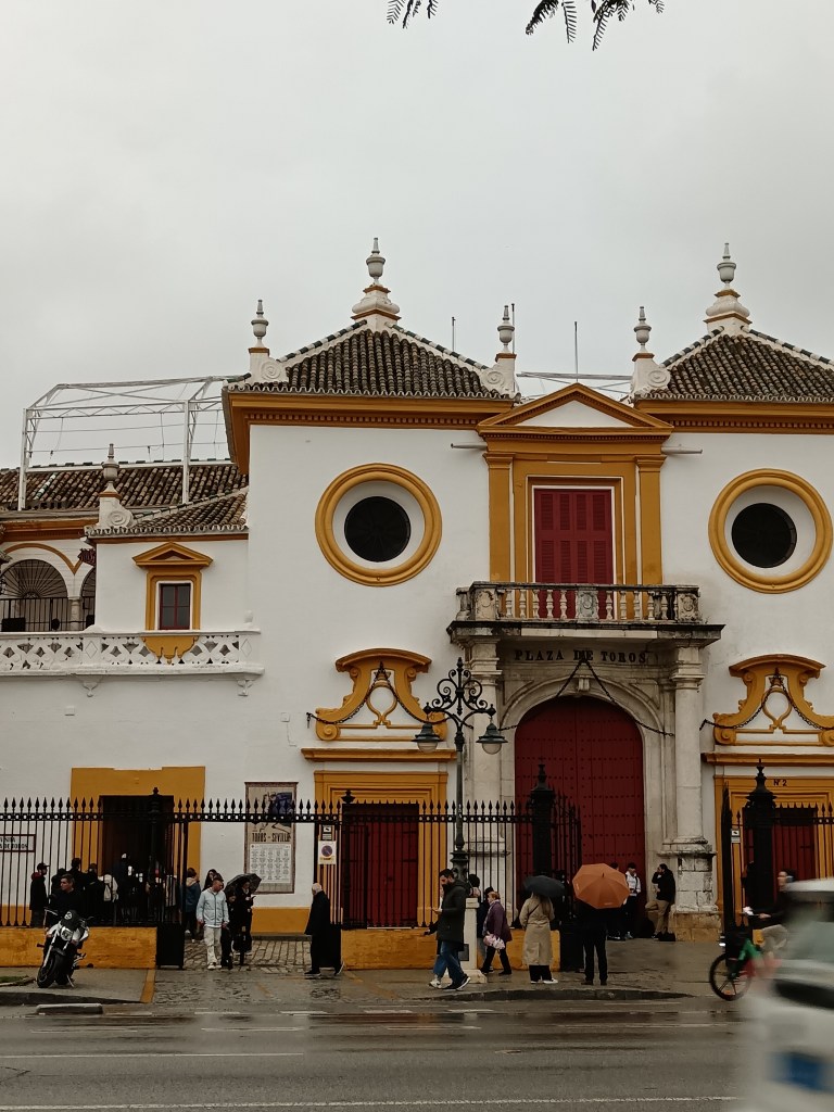 A grand white building with yellow and red detail