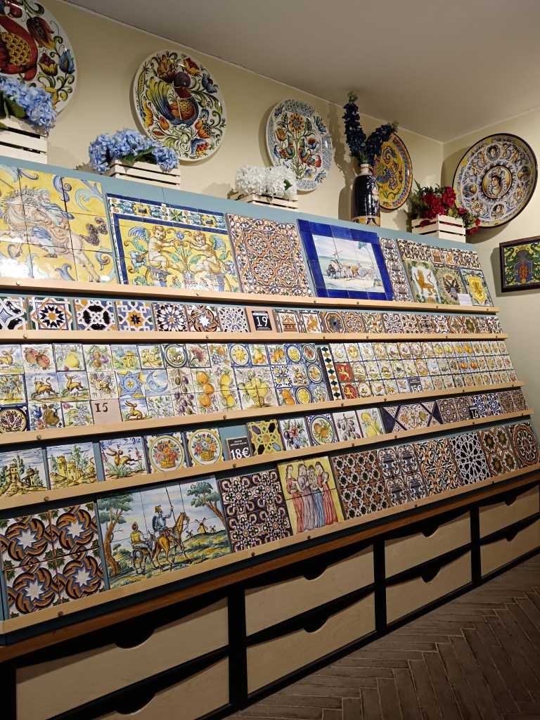 A wall full of beautiful painted tiles in a shop