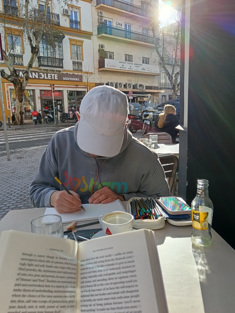 Ethan is sketching and I have an open book