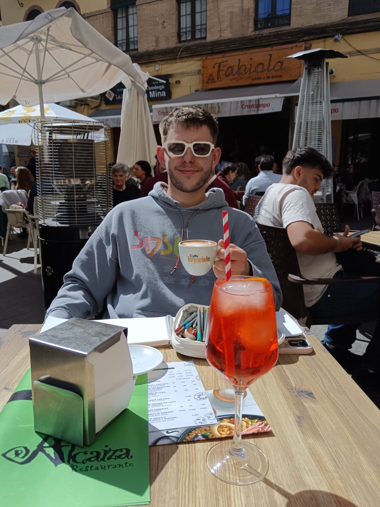 Ethan smiles with his coffee