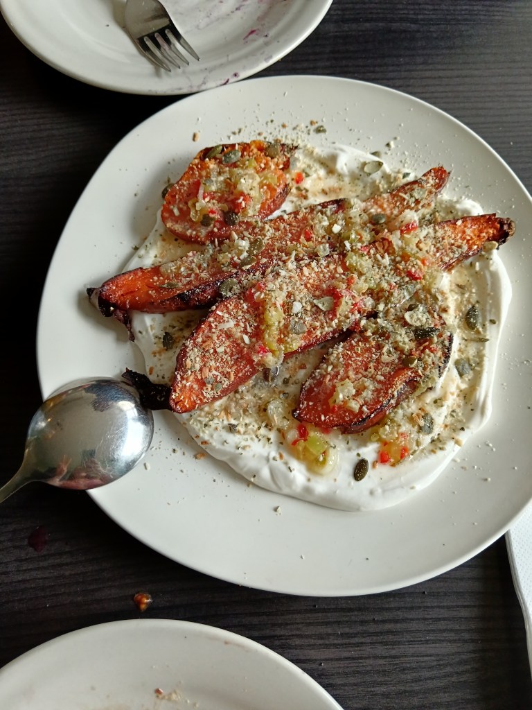 Roasted carrots sit atop a yohurt dip