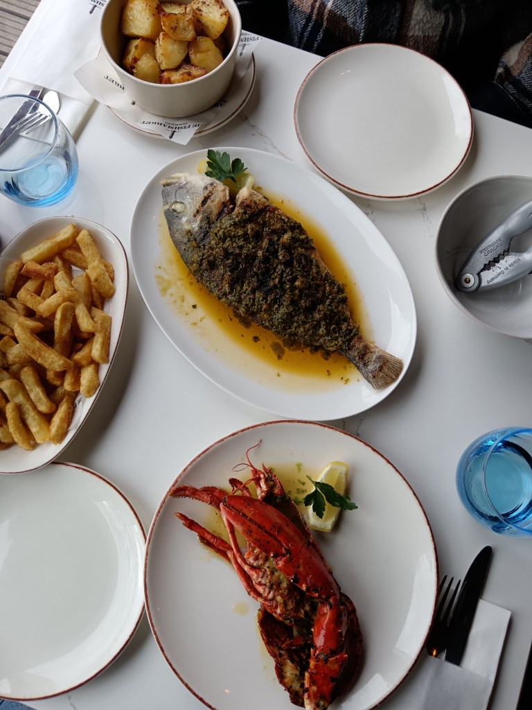 Plates filled with whole fish and lobster