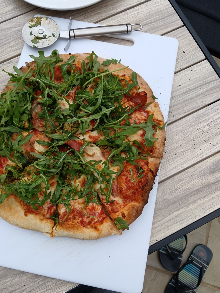 A delicious handmade pizza topped with rocket