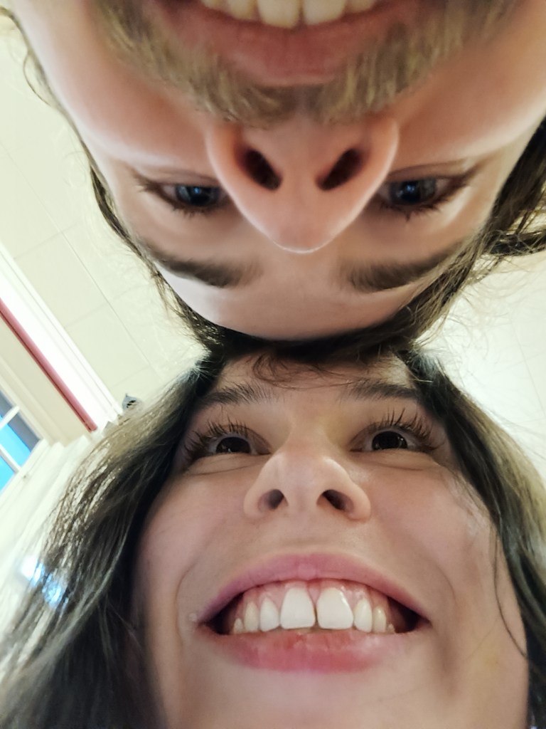 Kit and I put our heads together and look at each other