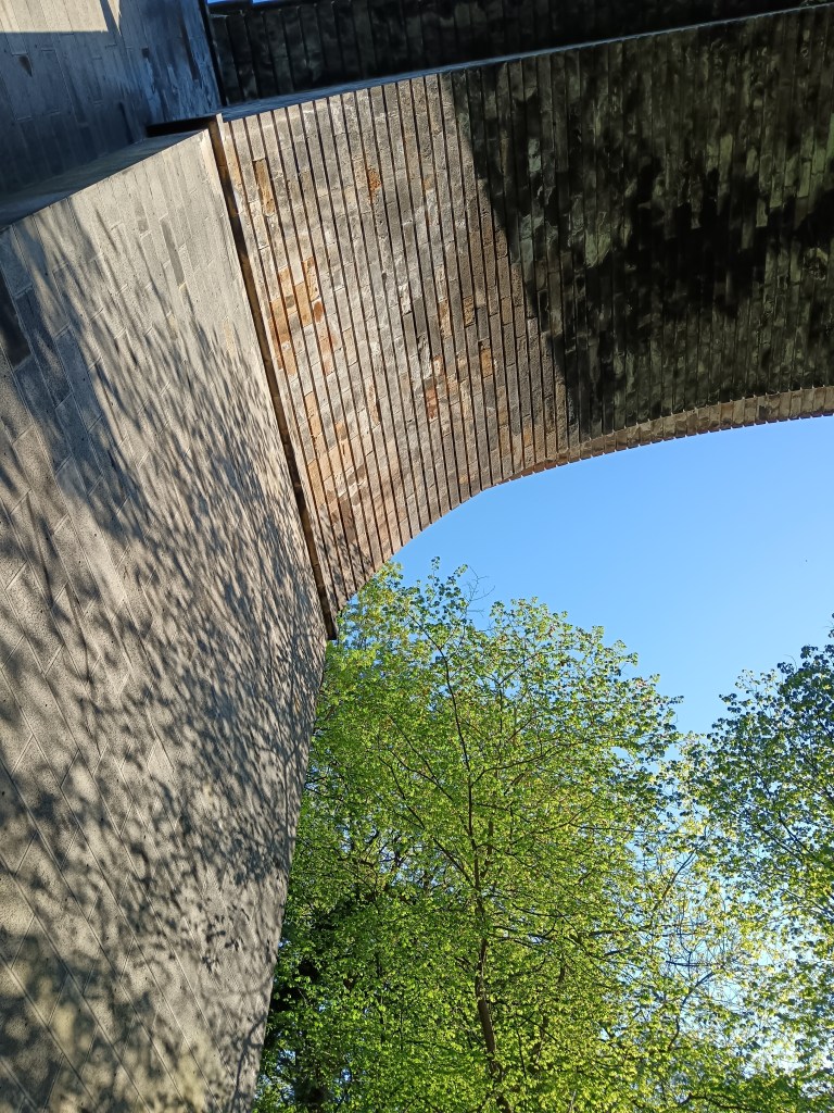 Trees throw shadows on a viaduct 