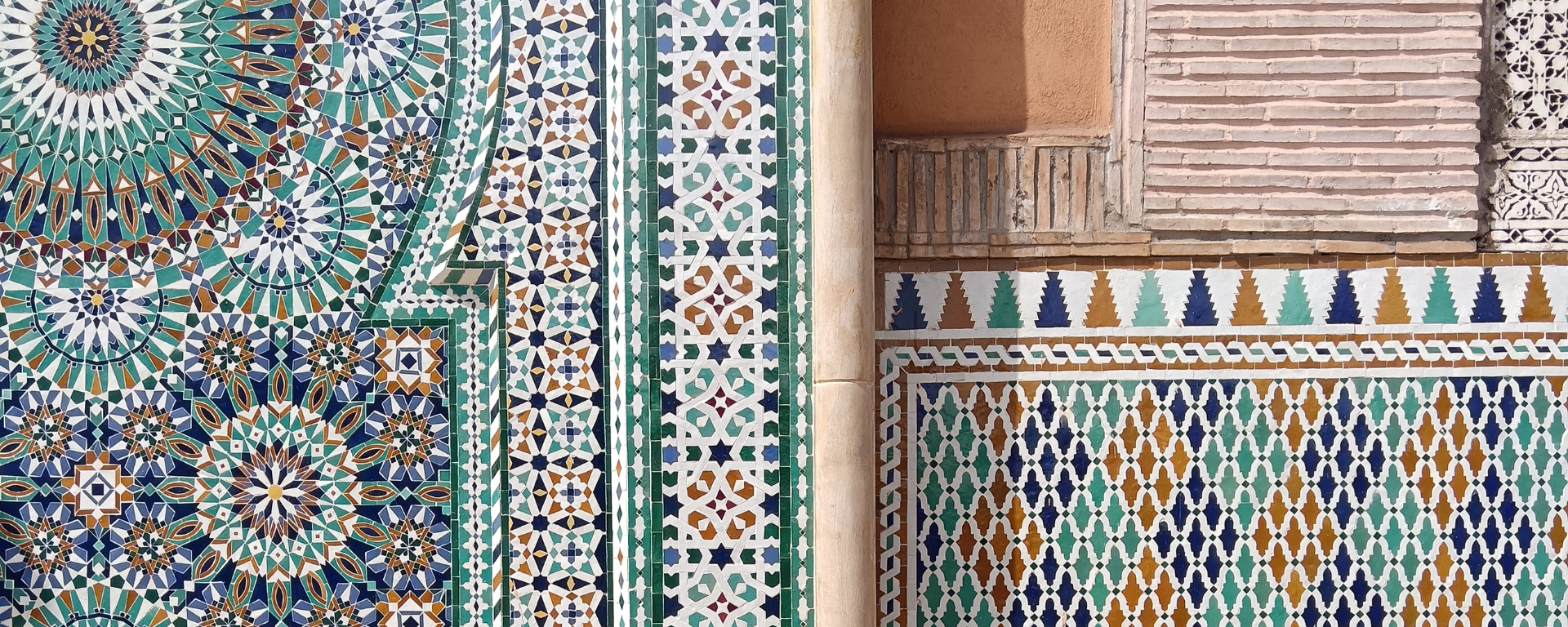 A wall with various colourful patterned tiles