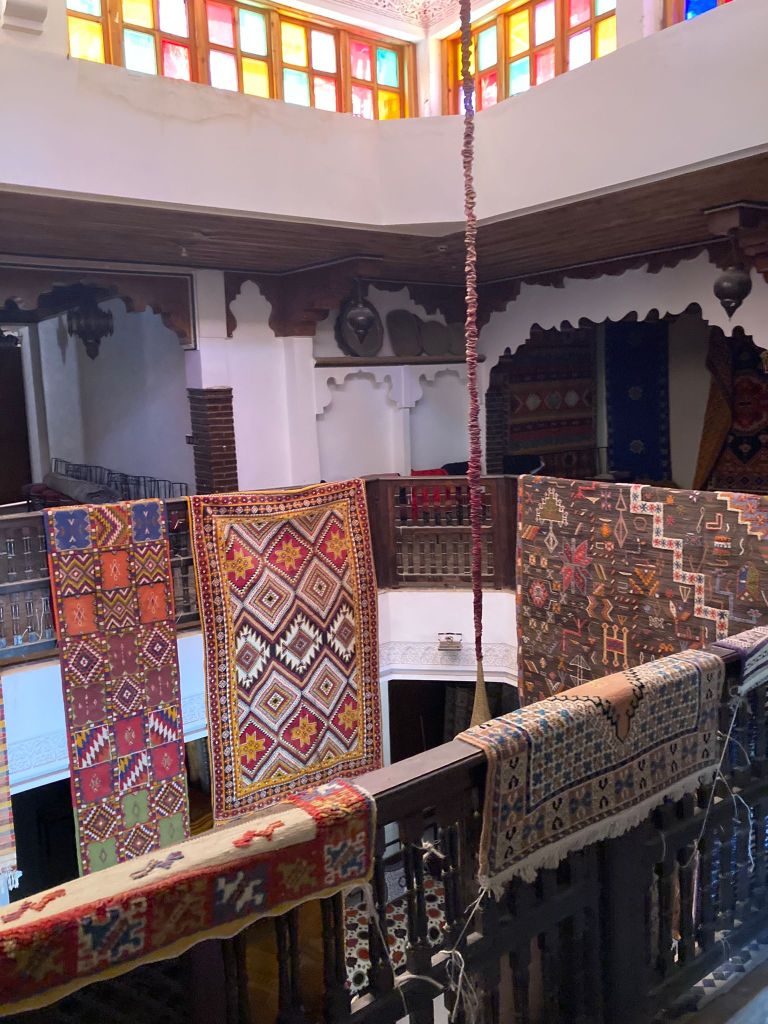 Rugs hang over a banister