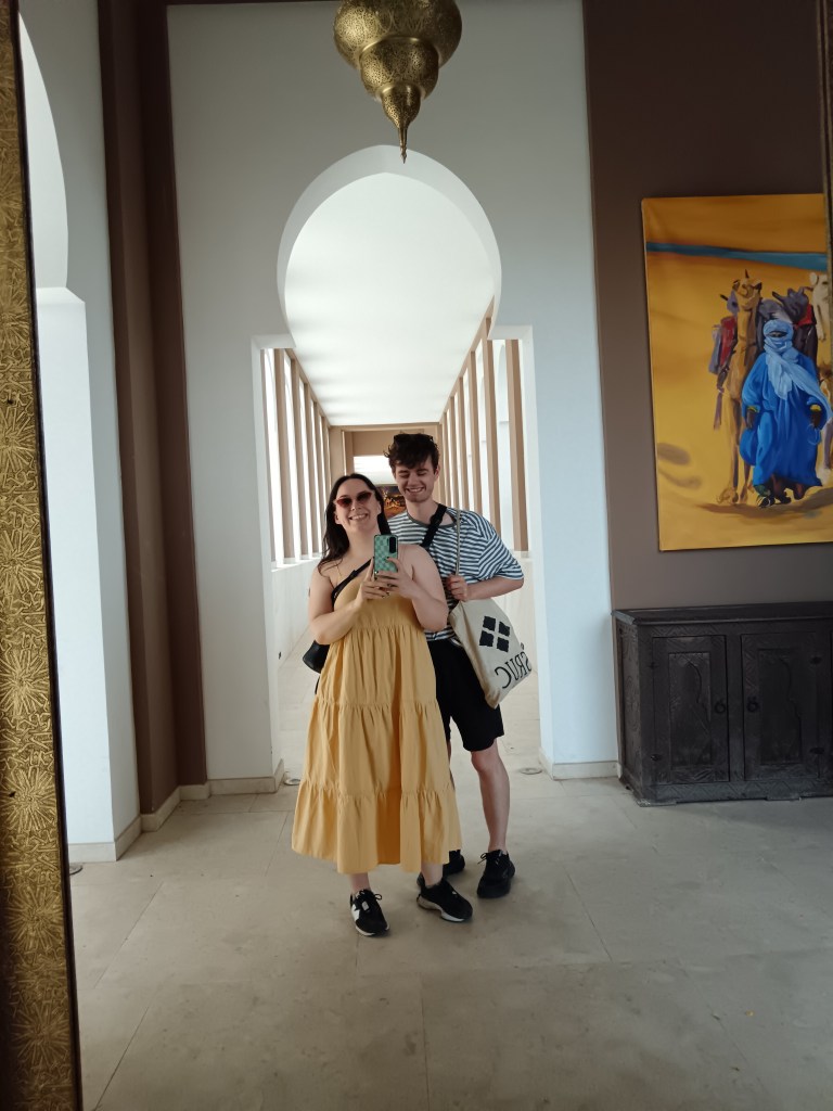 Kit and I take a selfie in the mirror, I'm wearing a tiered yellow sundress