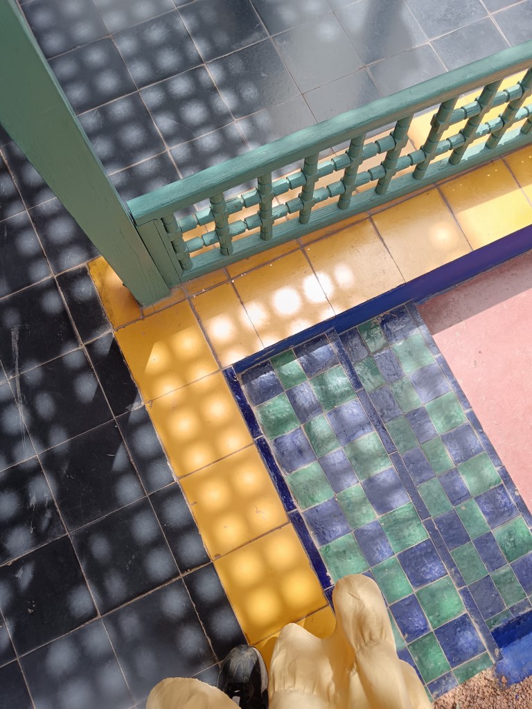 Sunlight casts small squares of light on a tiled patio