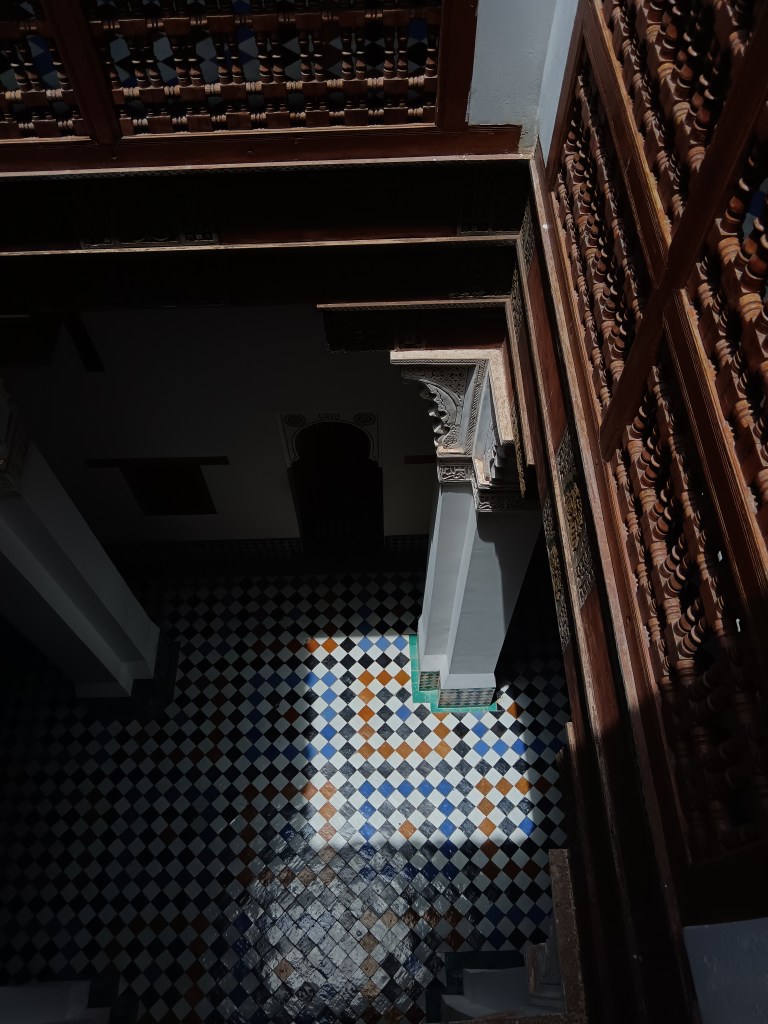 The sun cuts a square of light in a hallway