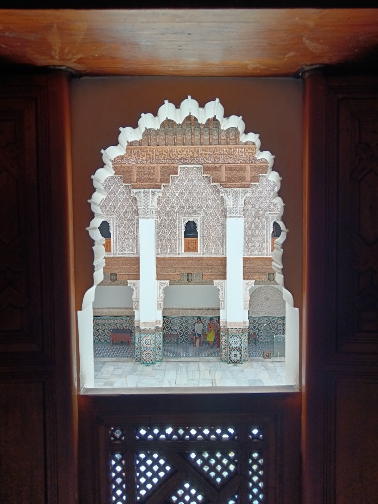 Through a window we see an ornately titled courtyard