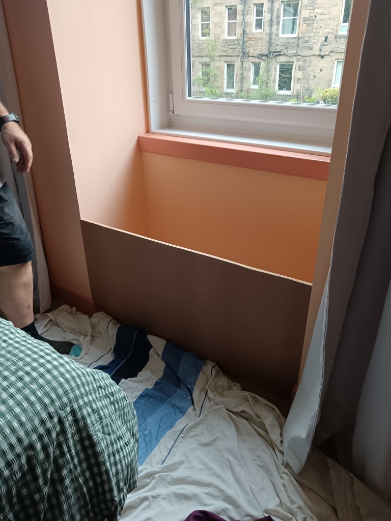 With dust sheets on the ground, my dad sizes up the front of the window seat
