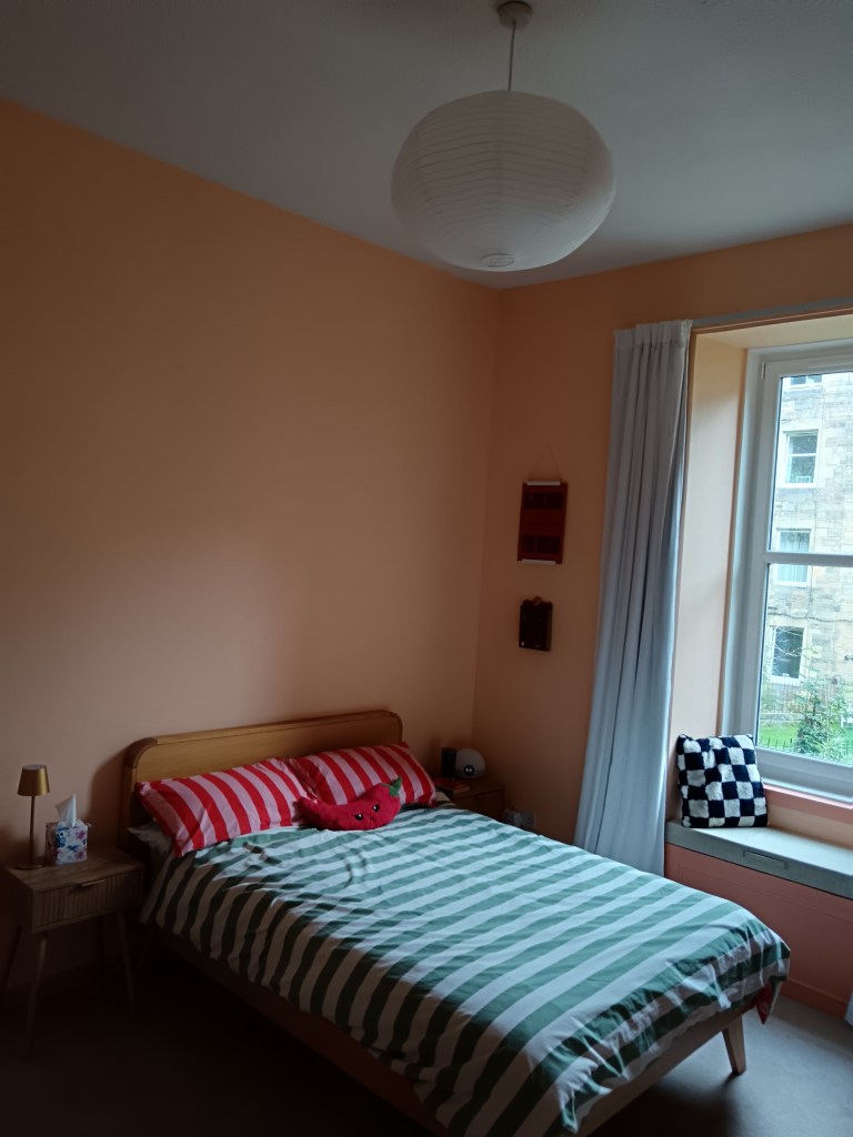Another shot of the bed showing the oval shaped paper lantern on the main light