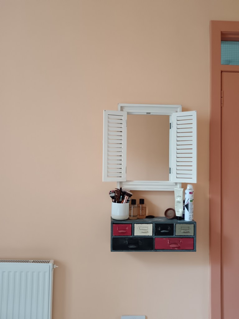 My wee vanity mirror is white and has open shutters, I have a vintage little drawers and have my make up brushes and perfume on top