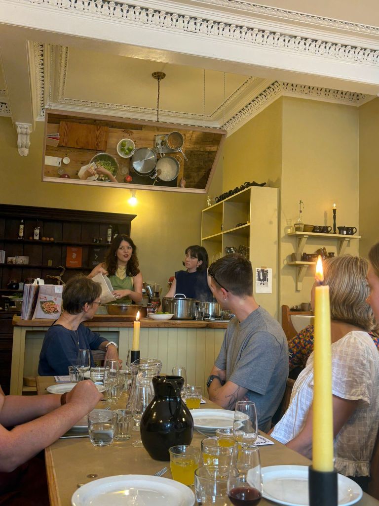 Julie cooks at a counter which is reflected in a mirror on the ceiling