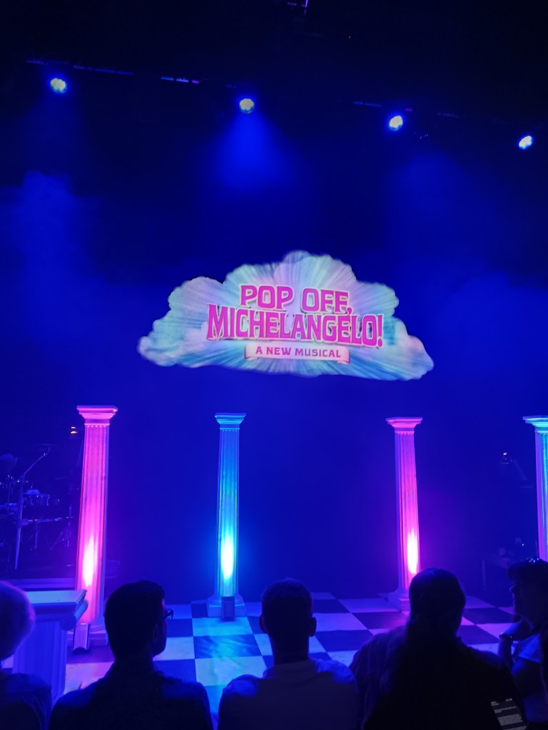 A cloud hangs over colourfully lit pillars