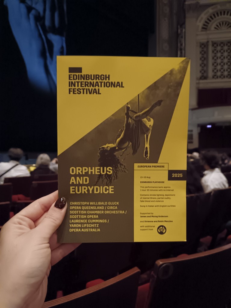 I hold a yellow programme for the circus opera